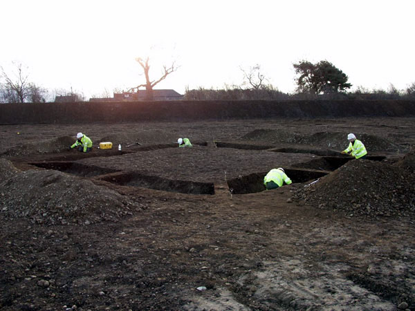 excavation team working on a square barrow