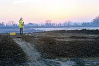 Working shot, surveying at sunset