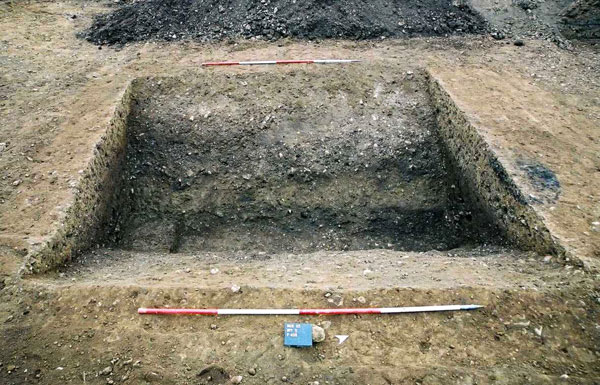 Iron Age enclosure ditch with later pit (section at left) 