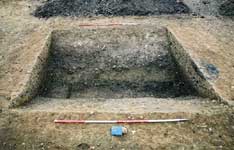 Iron Age enclosure ditch with later pit (section at right) 