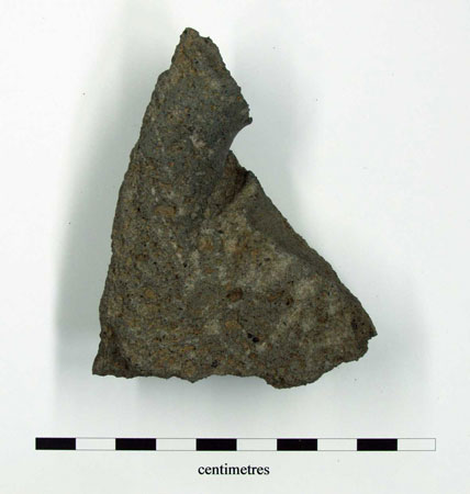 Small piece of upper stone with thong hole partially intact