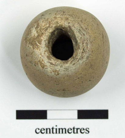 River pebble spindlewhorl, crilled with central hole. 27mm diameter, 24.5mm in height